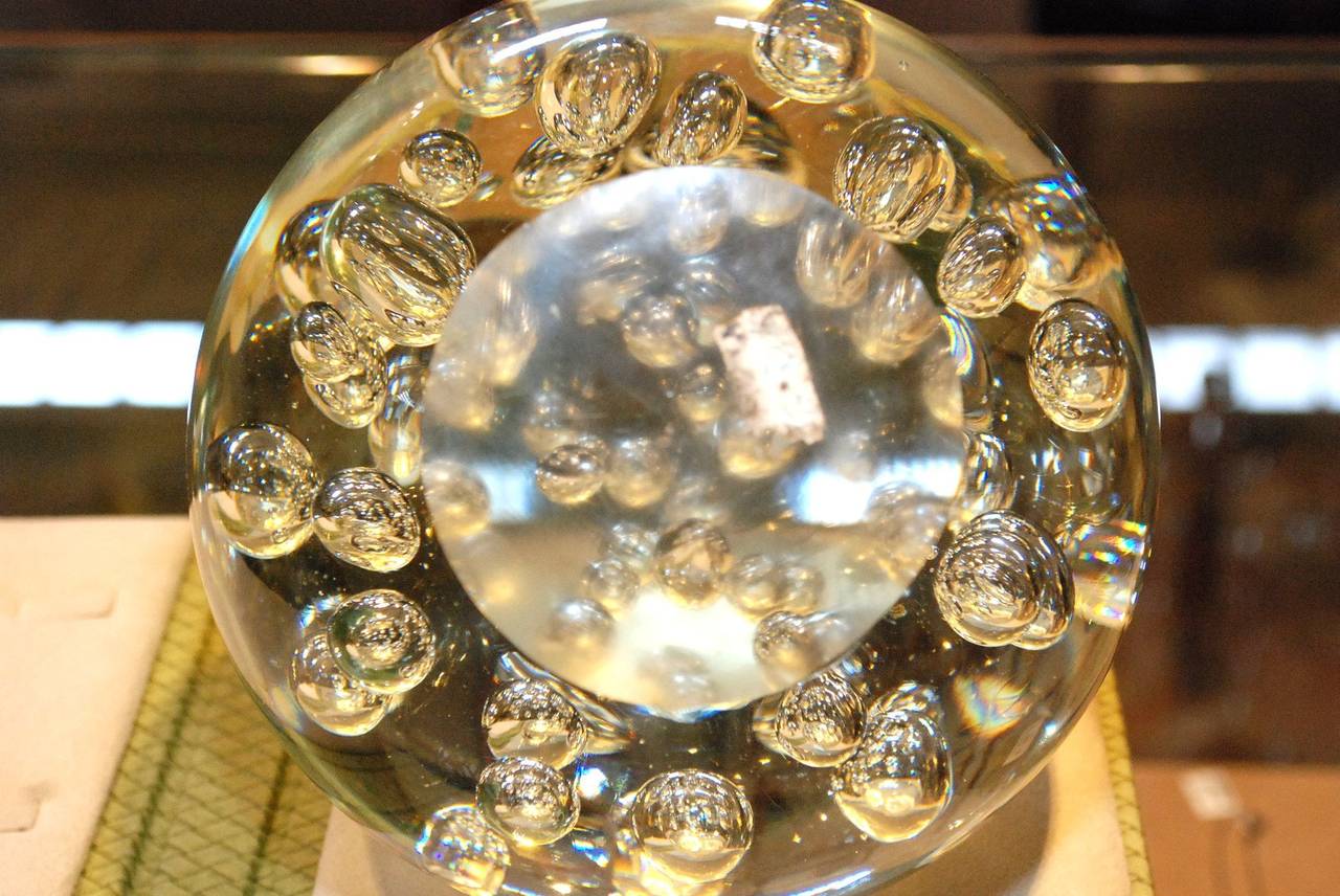 large glass paperweight with bubbles