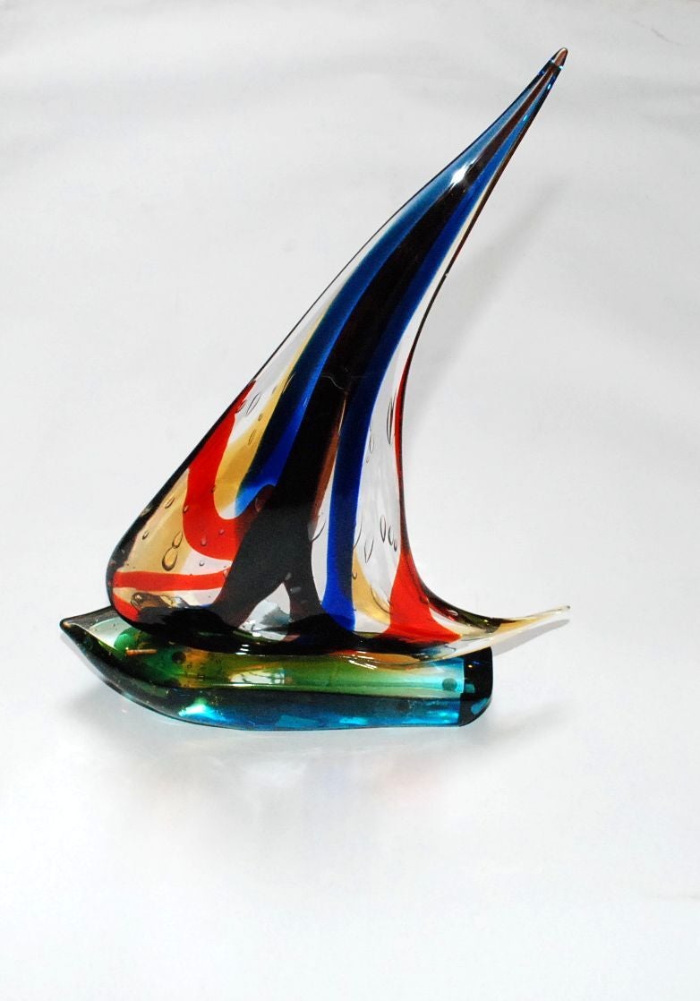 A colorful single sail Murano glass sailboat by Sergio Costantini. Signed by artist and also has a Murano sticker.
