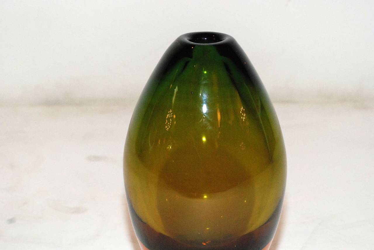 An elegant Seguso Murano glass vase. Colors range from orange to yellow to green. There is a factory flaw depression in the center of the bottom of the vase which you can see in the last photo. Also, there is a small discolored line on the lip of