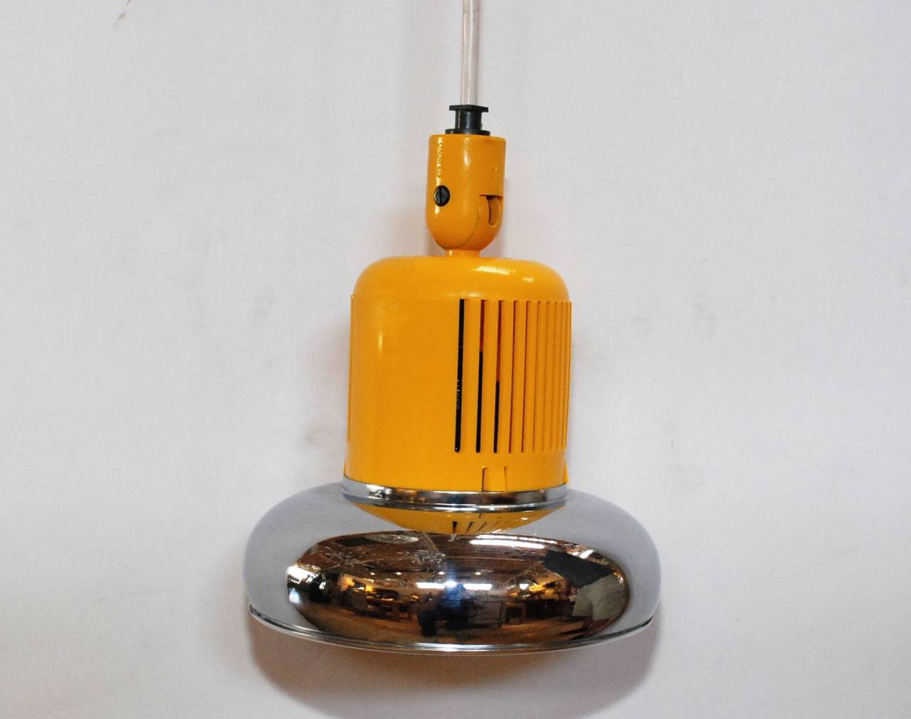 A colorful pair of Stilnovo pendants. Made of aluminum and hard plastic hanging on a thick rubber wire with a brass canopy. There is the impressed Stilnovo mark on the yellow section of the cone. Measurements provided is for the fixture only (rubber