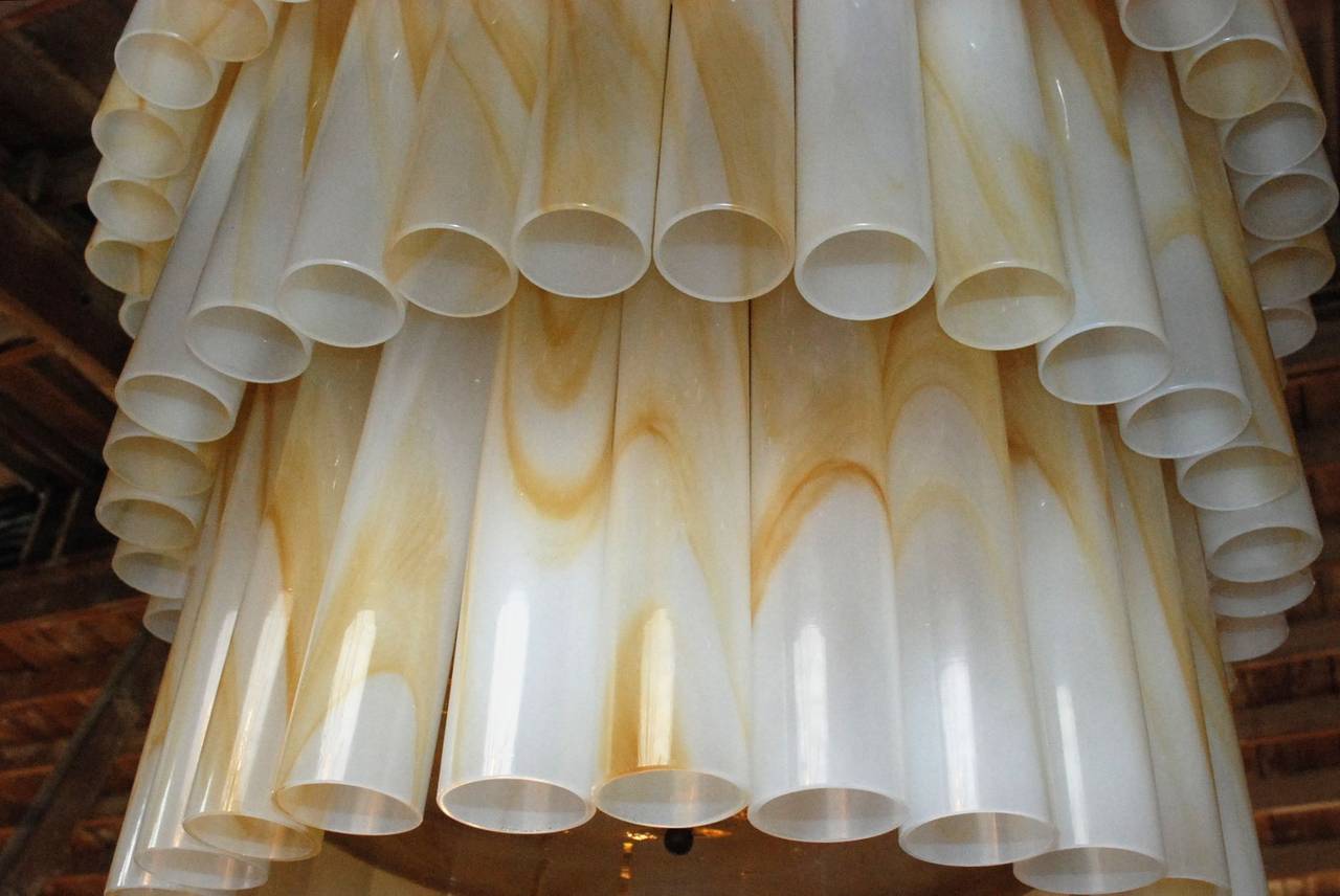 A vintage Venini marbled tube Murano glass chandelier. It has a creamed enamel frame and nine lights. Dimensions provided is for the fixture only (chain and canopy extra).