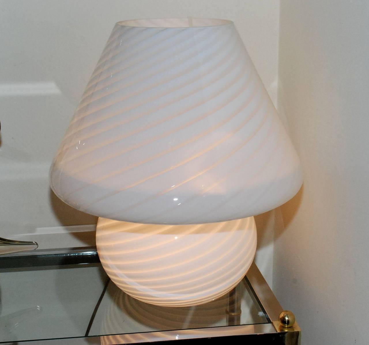 A vintage Vistosi mushroom lamp. It is made of white frost glass with a swirl design all throughout.