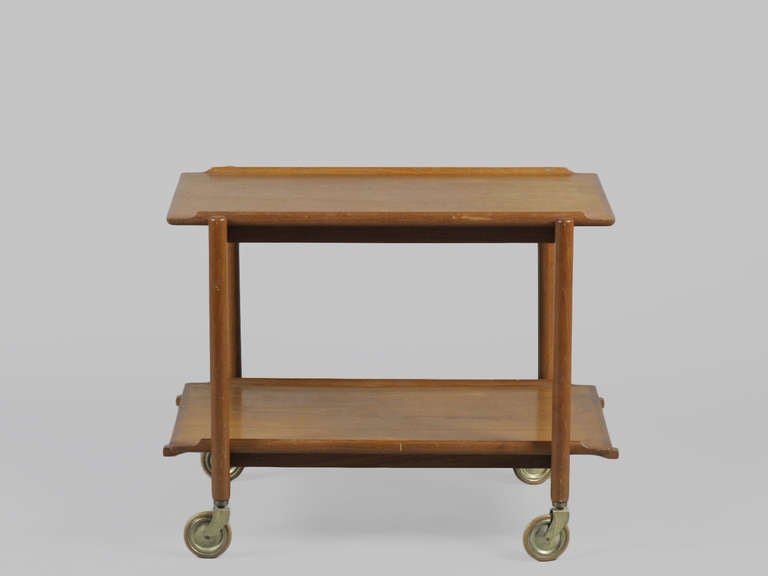 Elegant 1960's Danish Modern Teak Bar and Tea Cart. Remove the bottom tray and slide it next to the upper tray to double the size. Legs sit on rubber casters for easy mobility.
