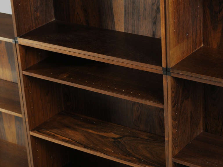 Collection of modular (25inch square) rosewood bookcases with ebonized corner detail.  5 left. 