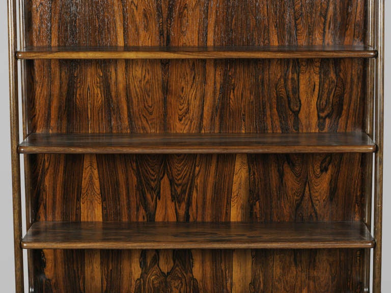 Handsome Tapered Rosewood Bookcase with pull down cabinet and 2 drawers at the base.  Solid rosewood frame with spectacular wood grain.