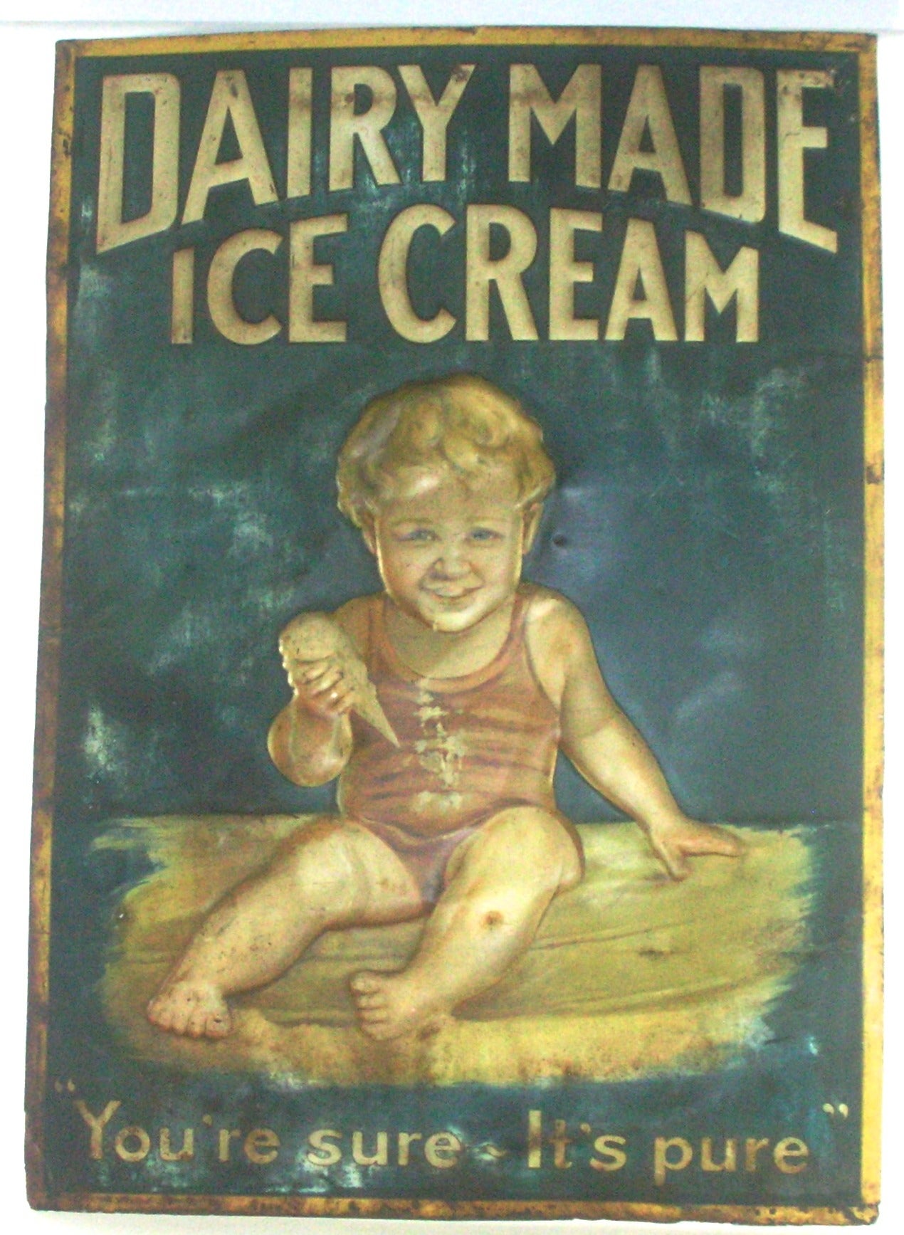 A wonderful lithograph on tin, embossed American vintage advertising sign. The sign is not often seen and is a charming design showing a blonde haired, blue eyed smiling baby holding and enjoying an ice cream cone. The Sub-script claims 
