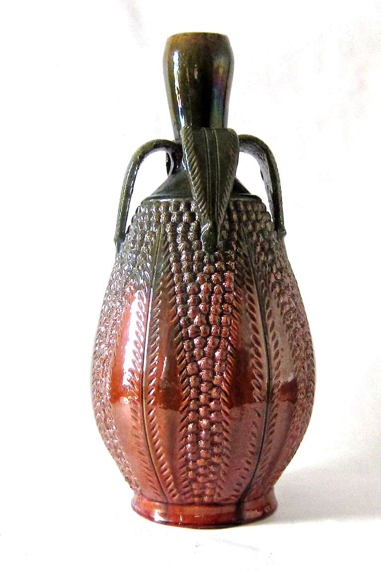 A fine example of vintage Mexican red clay glazed earthenware. The Pineapple motif is well detailed and a near perfect glazed surface with the exception of two small surface chips as seen in image 4 and 6. This specimen is good sized and shows the