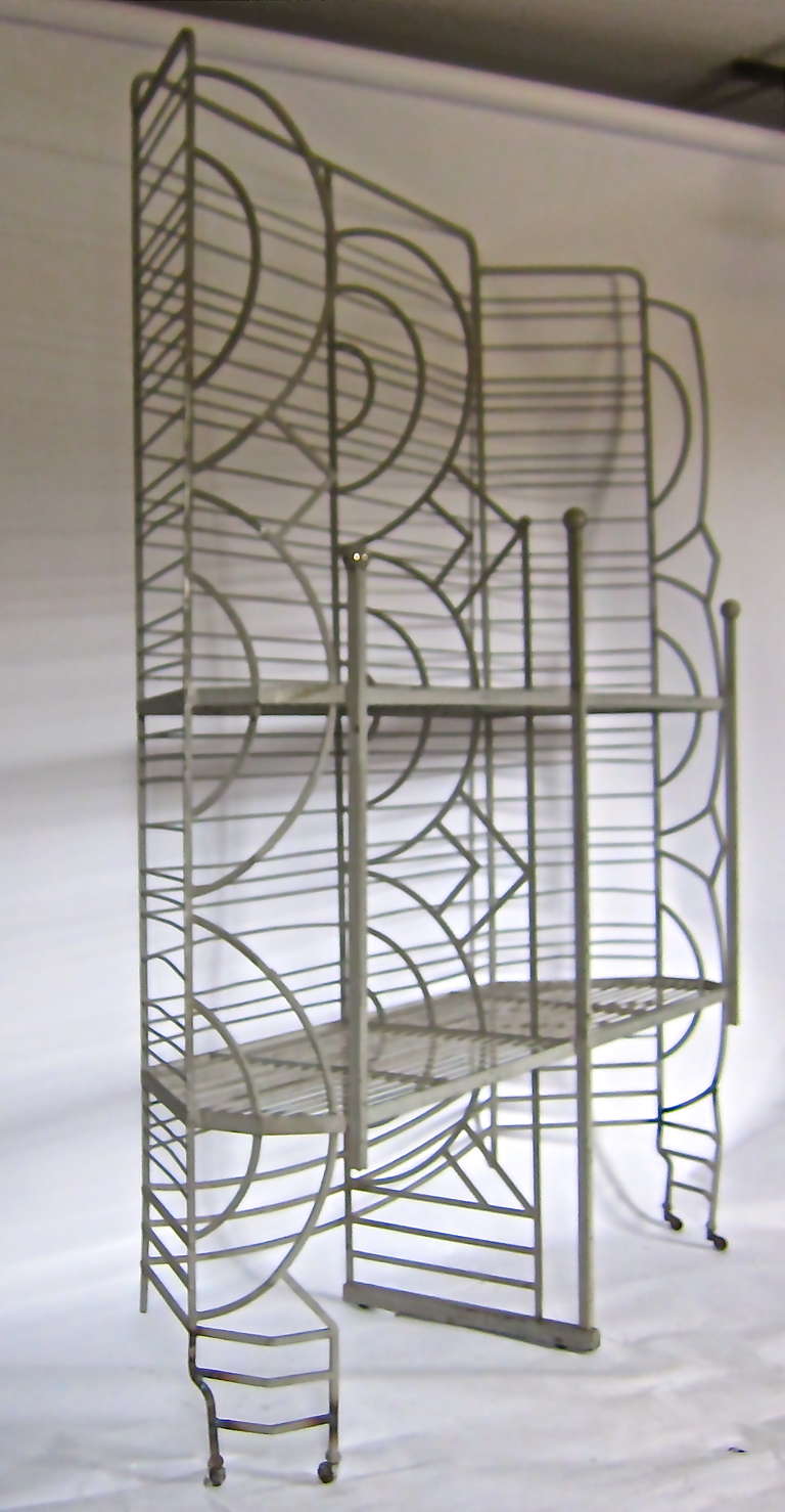 A stunning deco style store rack has graphic appeal and strong visual impact. An excellent plant rack with iron rod shelves allowing drainage. The shelving unit has casters on each end . A change of face from the usual design found in display