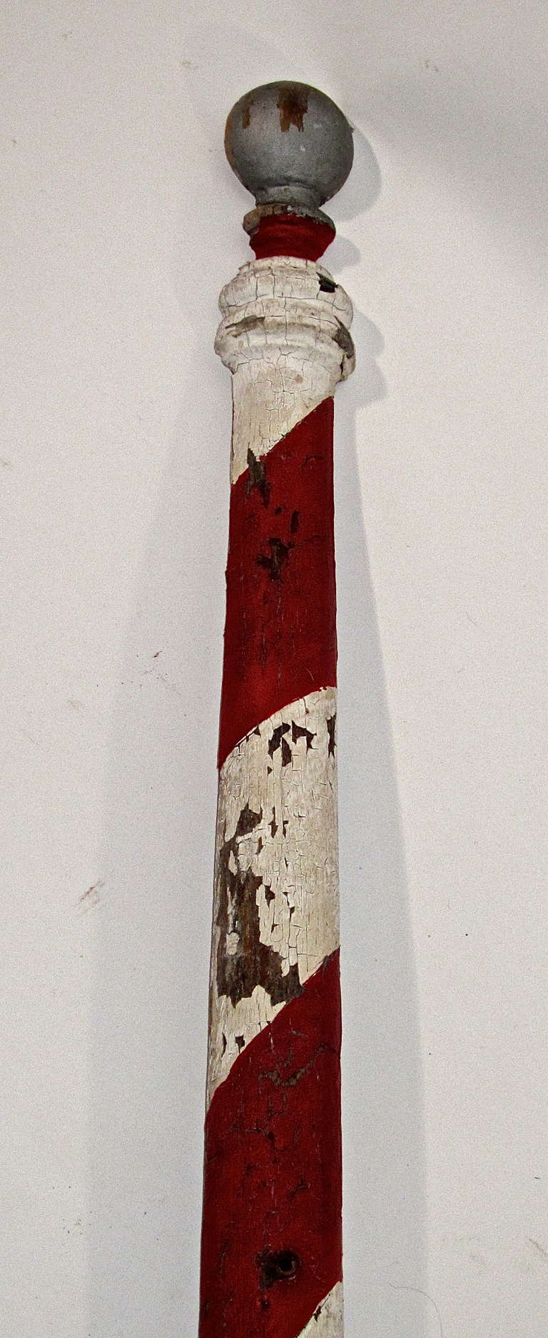 This charming slender half round barber pole is in   original painted surface . Sleek and slender, an atypical example of Americana.Trade signs designed and produced by craftsmen,