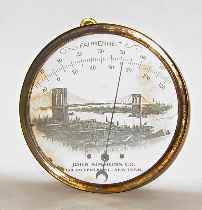 Celebrating the 1883 opening of the Brooklyn Bridge was a popular advertising theme of the day. John Simmons & Co., New York City gave these brass framed thermometers to their customers. Self hanger attached and spacers or feet on the back were used