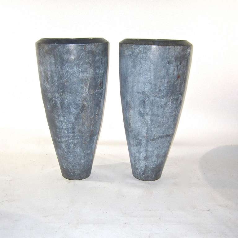 A pair of large  heavy duty enamel over cast iron conical shaped
industrial vessels. The enamel surface is smooth and a variable gray toned color. A beveled opening reveals the full interior cavity. The dimensions are 32