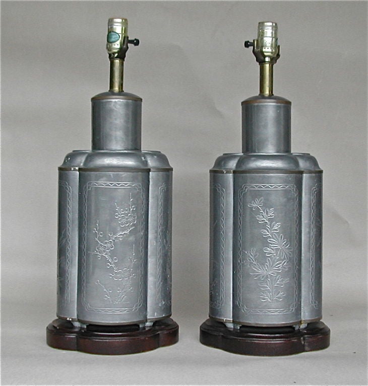 An early 19th century pair of tea caddies with attractive floral motif engraving and self footed, mounted on formed wood bases as table lamps.