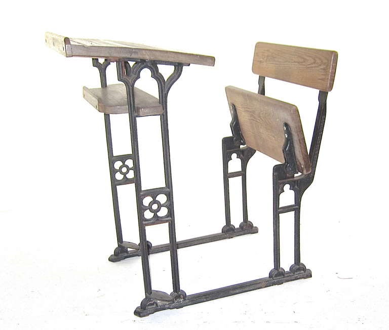 This single sized writing or student desk was made by one of the early school furnishings manufacturers in London. The seat raises for easy access . It is a fine specimen of the schoolhouse furnishings of the time. A most adaptable size for most