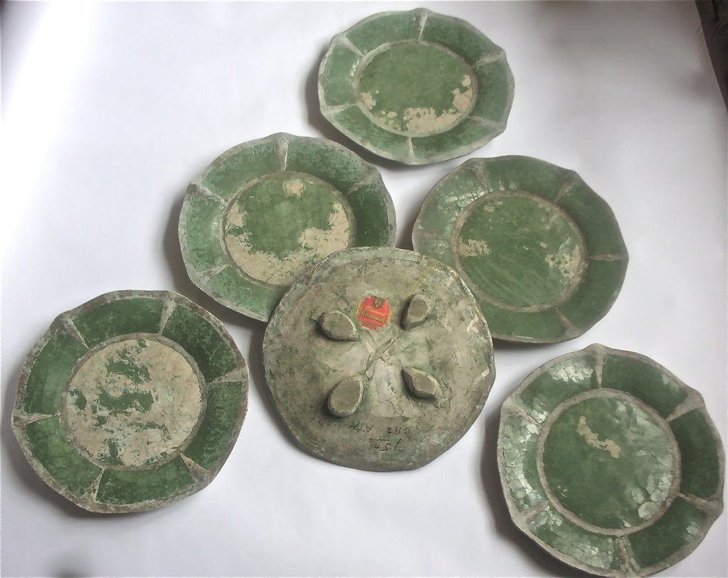 A rare find of six signed Bouckware plates bearing the trademark label and patent number on four of the plates. Bouck White, the maker was a minister, writer, social activist and a potter. His patent was for a glazed finish on pottery without