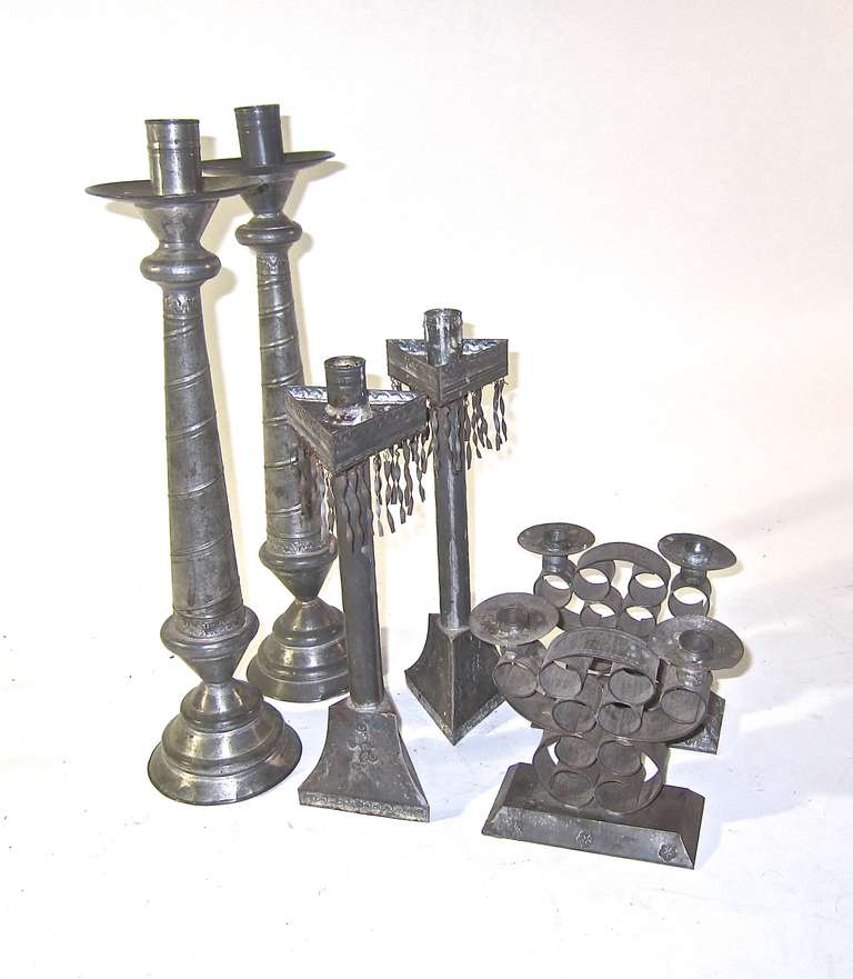 Three early examples of tinware from Mexico in the form of candlesticks showing the depth of skill and design offered to the tourist trades. Each pair has their own personality and appeal for your tabletop use. The two taller pairs have weighted