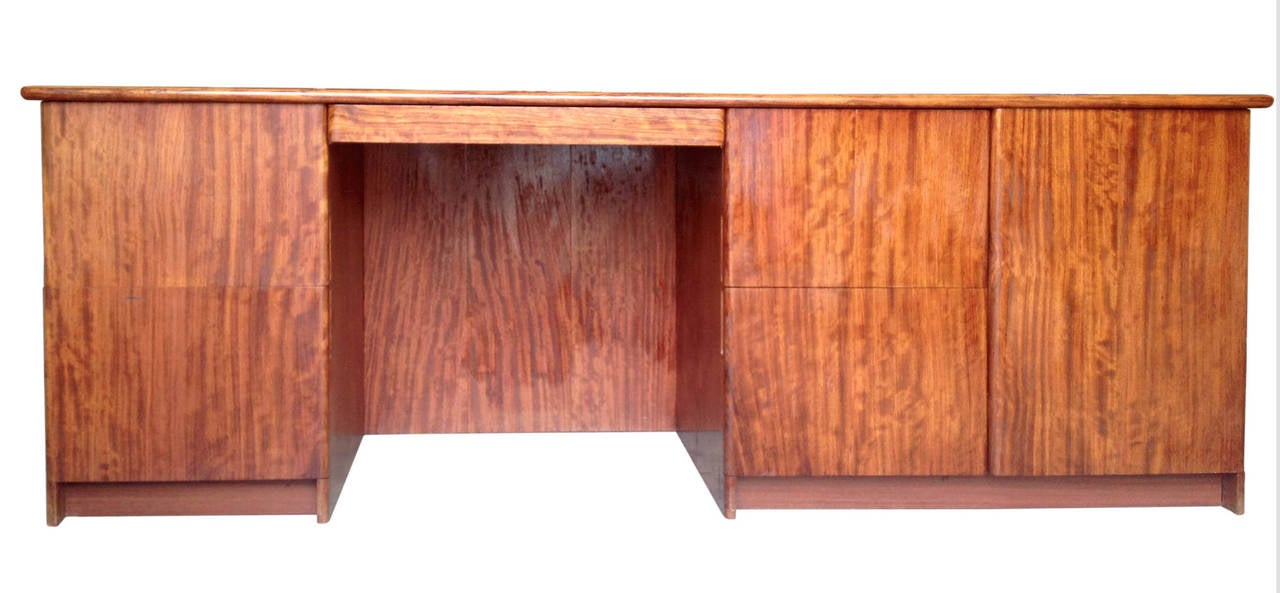 This desk is both functional and beautiful with its numerous storage spaces and gorgeous natural wood grain. The seat location is flanked by two file drawers on either side, with a shelved cabinet at the far right.
Its narrow depth allows to put it