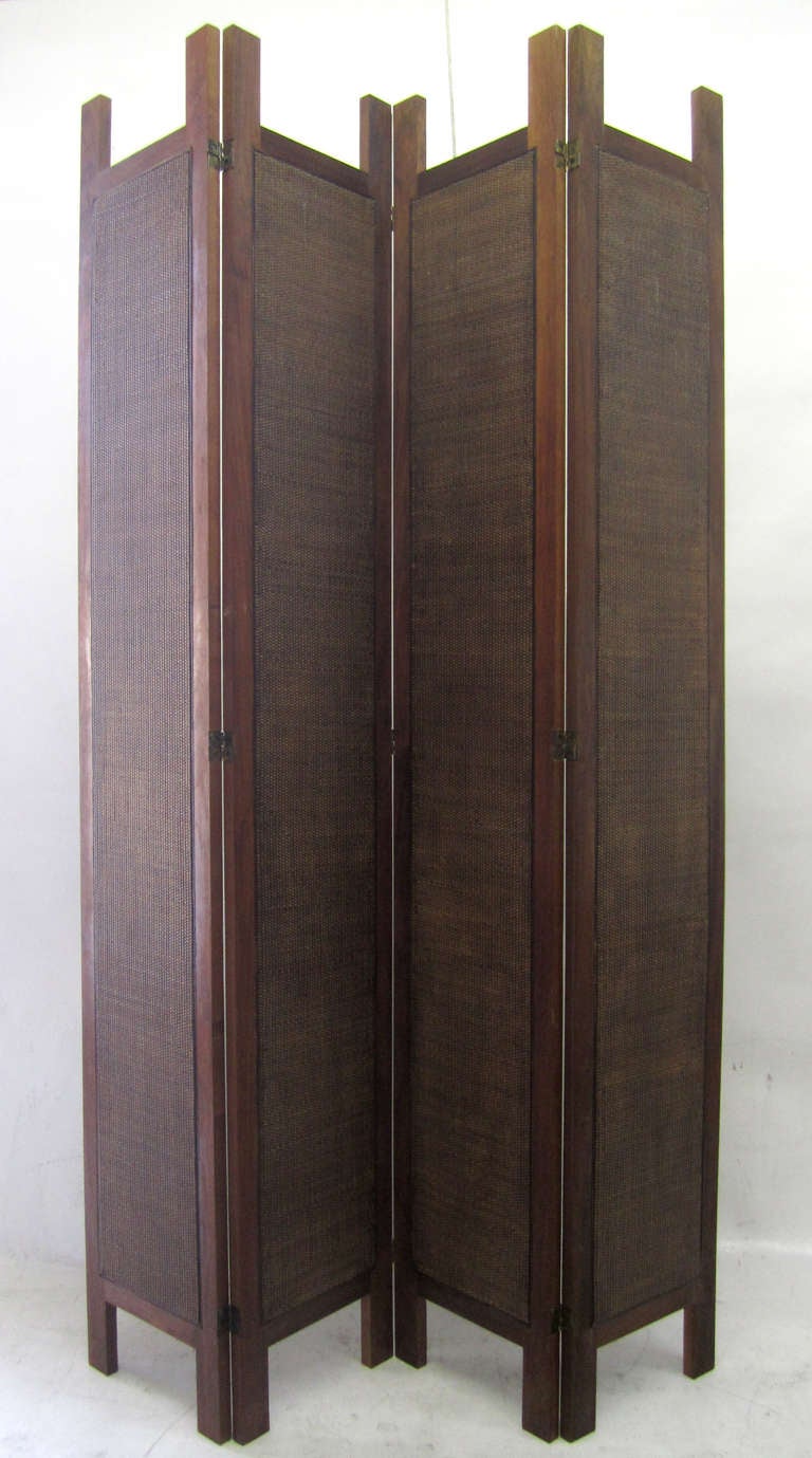This mid-century modern screen features four walnut panels, inset with woven rattan in the same tonality. The screen measures 96