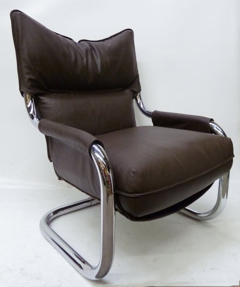 This chair frame is made of large chrome tubing and it has been recovered in a thick yet soft  brown leather.
It's extremely comfortable.