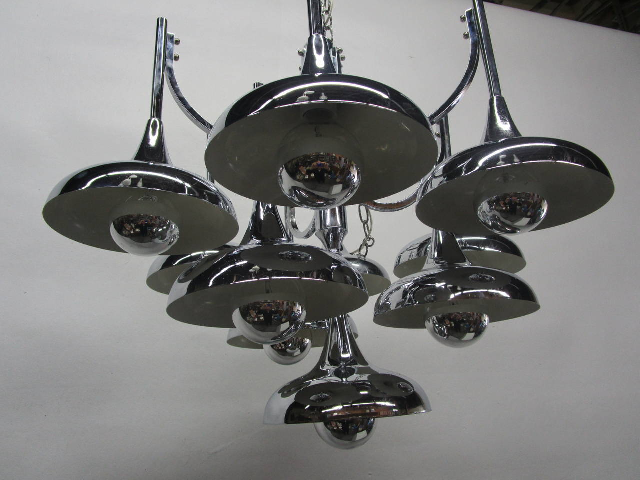 This chrome chandelier features ten bell trumpet shaped lights. The chrome-crown bulbs give a very warm and consistent light without hurting your eyes!
The chandelier height is 26