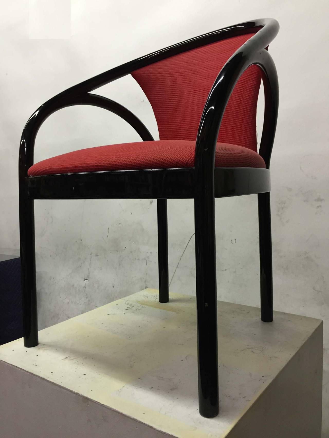 A pair of black lacquer tubular black lacquer wood chairs covered with their original raspberry fabric which is in very good condition.