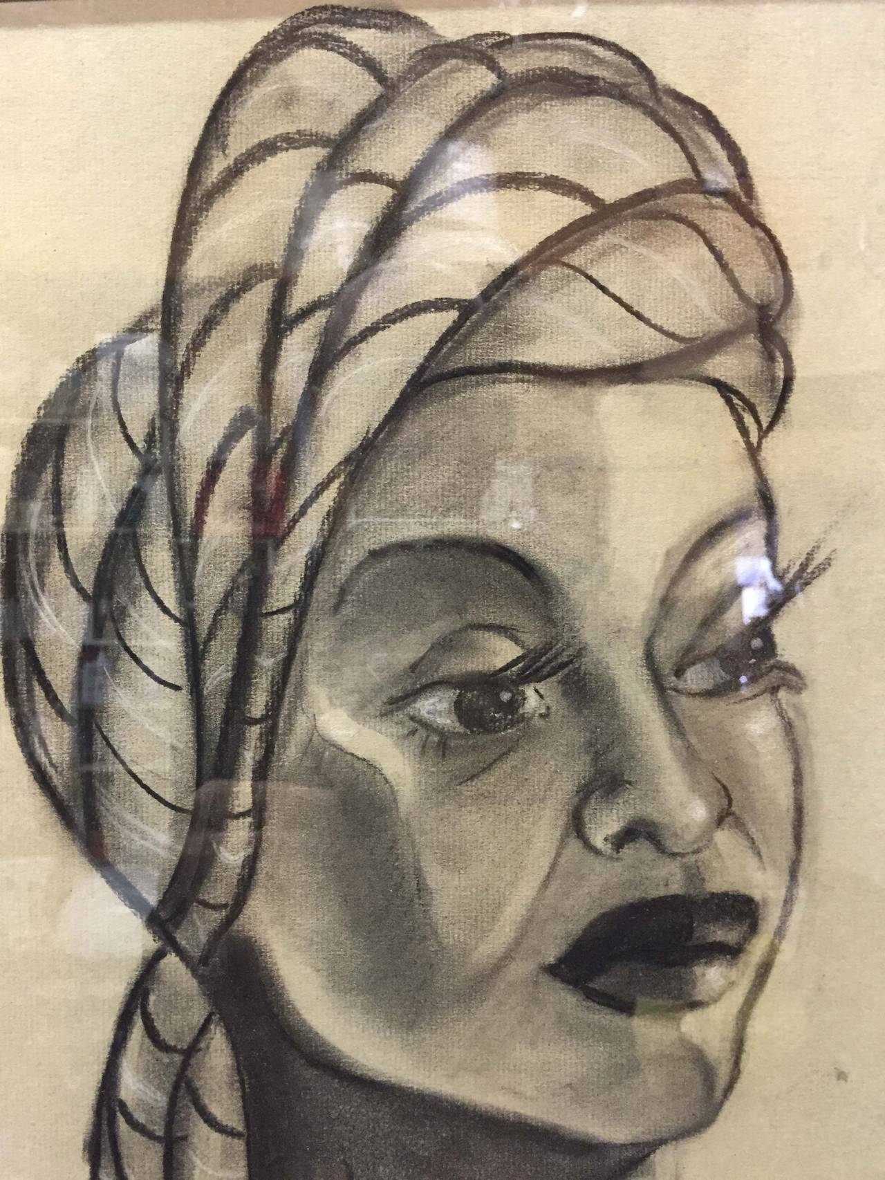 Charcoal portrait of an unknown beautiful African woman. The drawing sits in its original ribbed frame. It is signed 