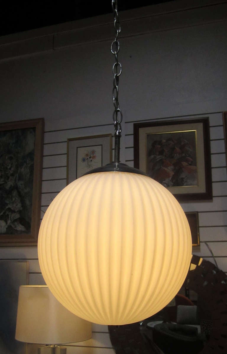 A pendant light in opaque white ribbed Murano glass. The lamp hangs from a  6' long chain and chrome pendant holder.

**Please see our listing for a matching pendant in a cylindrical shape. Last two photos show these products side-by-side.