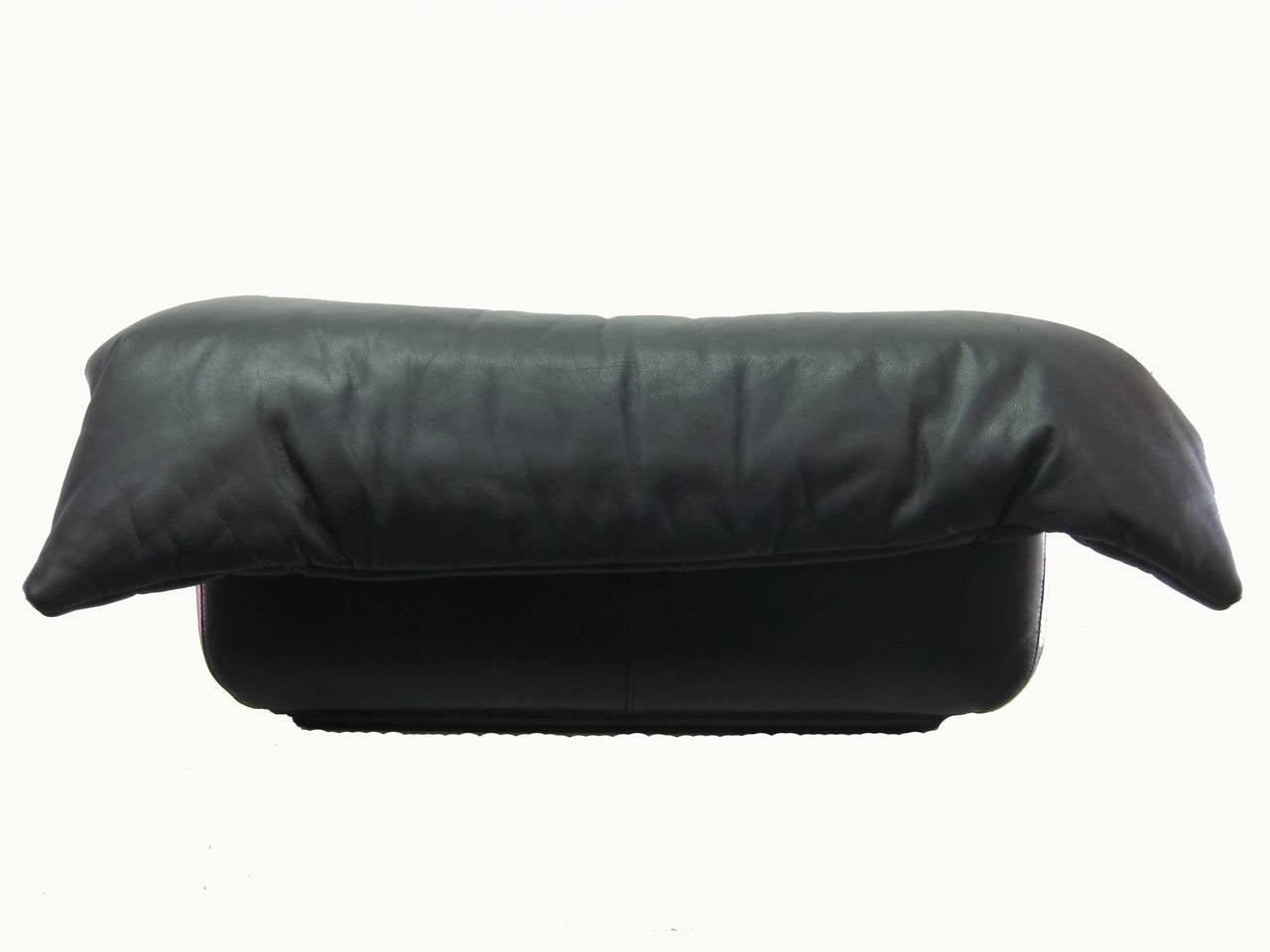 Black leather ottoman made by Ligne Roset.