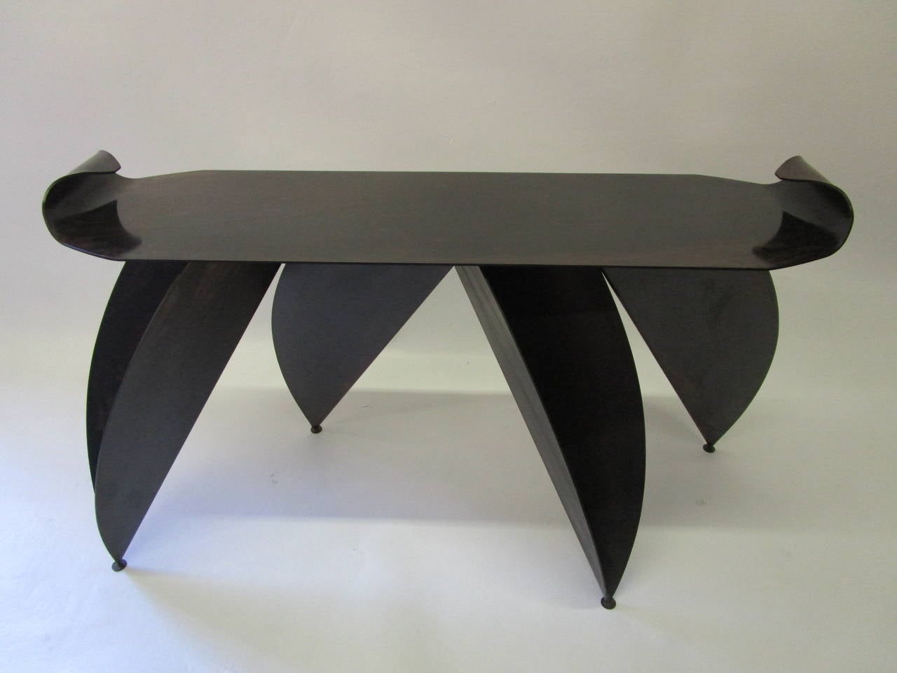 This console is the work of an artist. It is a strong and unique piece which looks like a big bug.
The legs are composed of four open metal sheets which support a metal top with curved edge ends. The patina on the whole piece is amazing. The