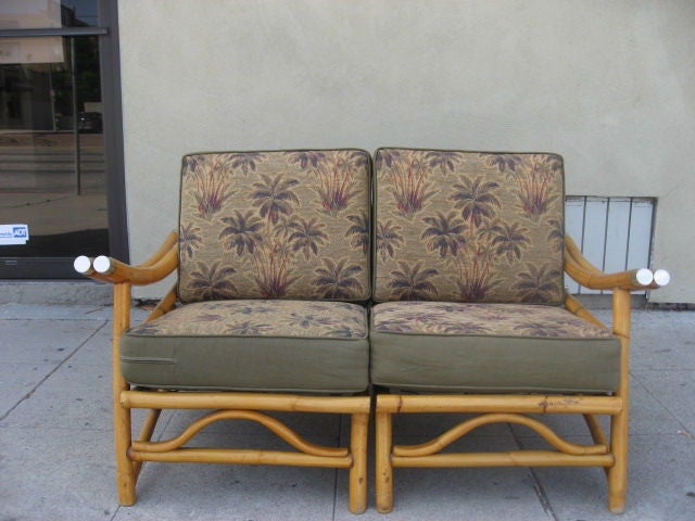 This three piece couch can be set up in several ways, as each section can be its own chair. Reupholstered in vintage Hawaiian vintage fabric, the bottom cushions are held upon springs whereas the back cushions lay upon the bamboo frame. Chrome caps