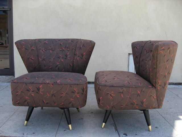 Pair of swivel slipper chair with black wooden legs and brass 