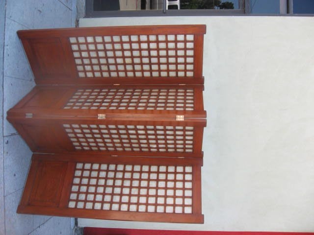 Four panel screen with a mahogany frame and abalone inserts..