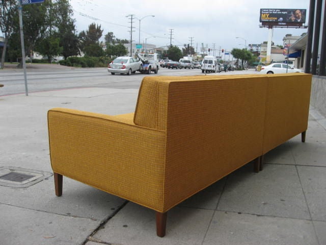This mustard yellow two piece sectional by Paul McCobb can be put together or separated. Each sectional is 49