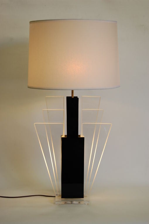 This lamp has two-light sources. One light source lights up the shade and the other lights up the base.
The shade is made of translucent paper.