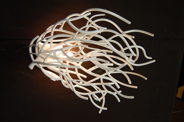 A pair of sconces made of white powder coated metal branches looking like coral.