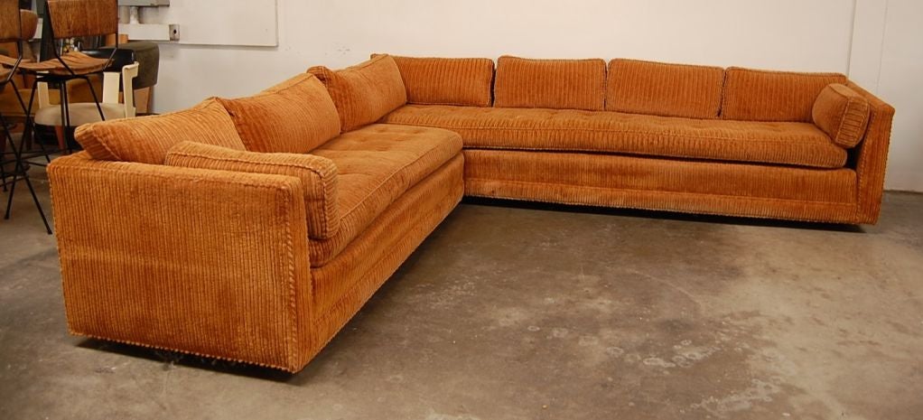 Large L-shape sectional sofa from the 1970's. The seating sectional is made of two segments that join at two ends to make an L-shape.