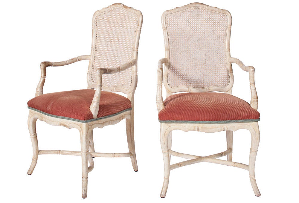Set of 8 Louis the XV dining chairs  from the 1960's. The set includes 6 standard dining chairs with a light green upholstery and 2 end arm chairs with a light orange rust upholstery. The frames are constructed in white washed painted wood frames