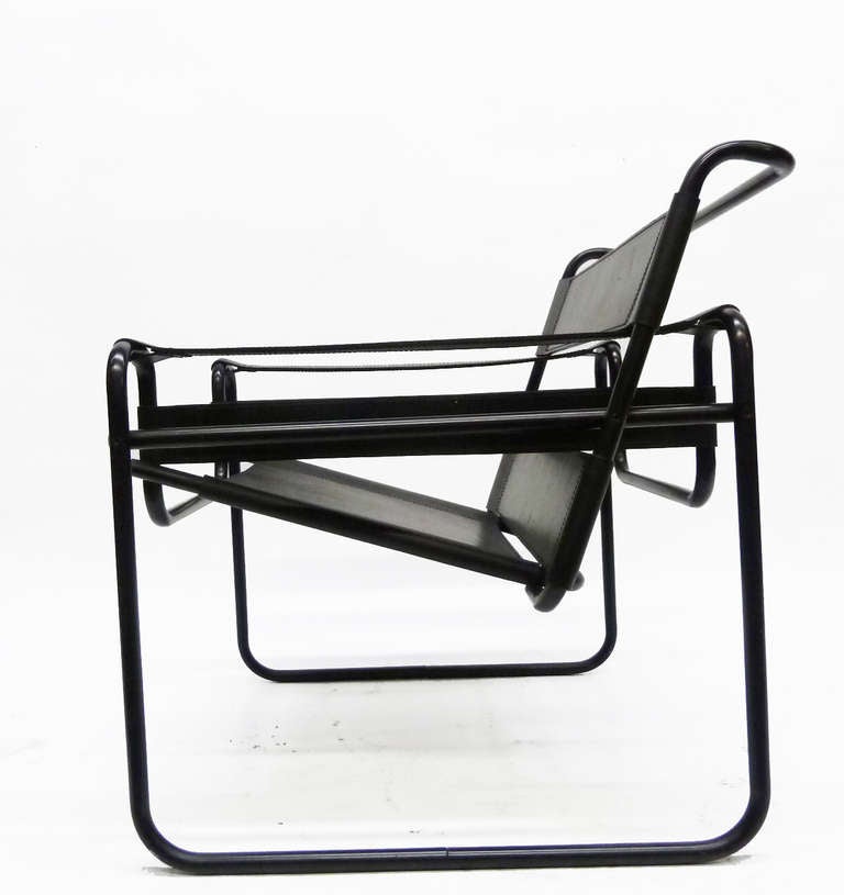 Marcel Breuer's classic Wassily design, this lounge chair features a rare, tubular steel frame in matte black instead of standard polished chrome finished. Further complementing the De Stjil / Bauhaus aesthetic, the straps of the chair are also