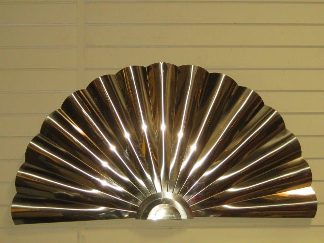 Brilliant wall sculpture in the shape of a fan created by C. Jere from the 1970's. The piece is made of  solid brass and is designed with a wave like design for the fan. A certificate of authenticity label is attached to back of the piece.