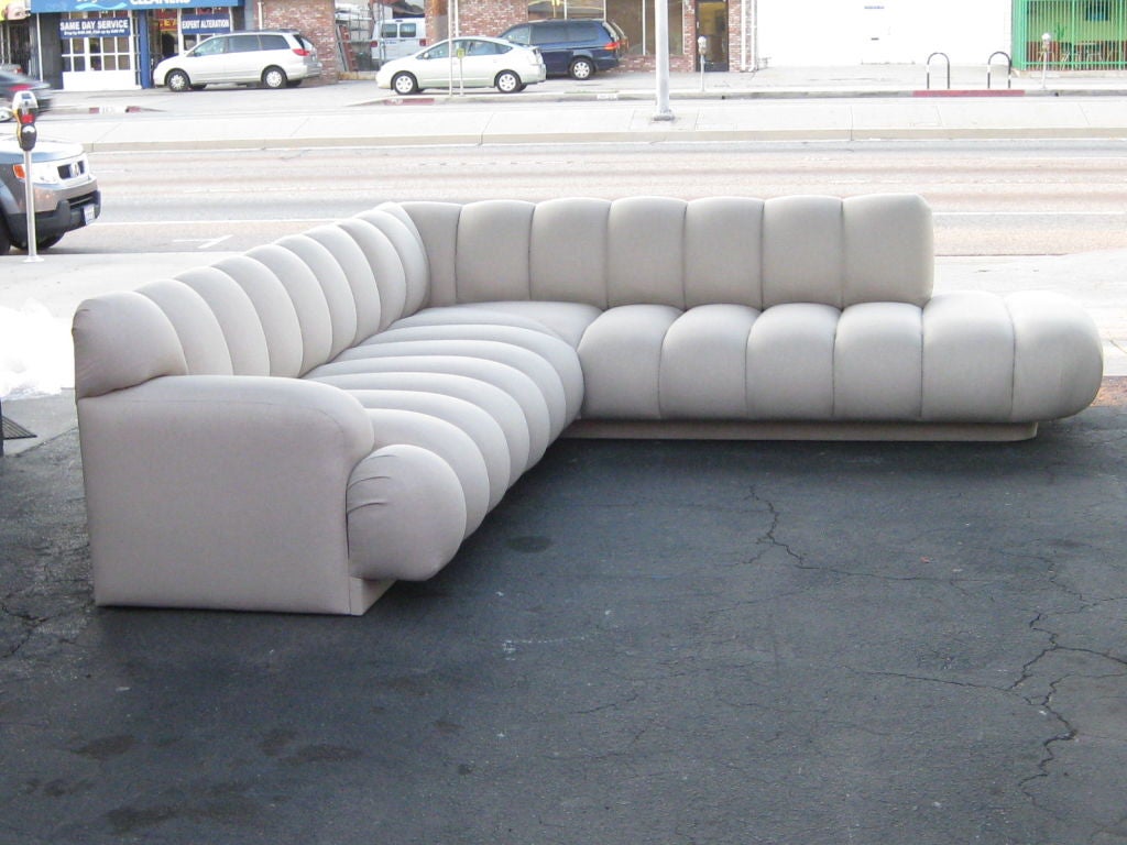 This sectional is constructed of two separate seating parts that join to make an L shape. Extremely comfortable and sleek.The length of it is 125