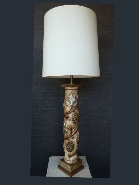 Gilded grapevine and silvered leaves ornate the shaft of this lamp which stands on two bases, one silvered, the other one gilded. The unusually high height of the table lamp shows off the splendid crafted work done on the shaft.
Shade is not