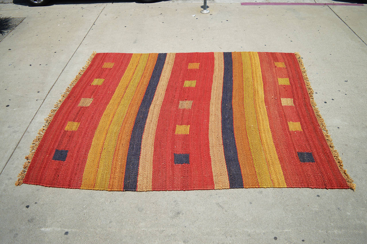 Hand made Moroccan rug made in hemp custom dyed in red, yellow, black and orange with natural fringe binding