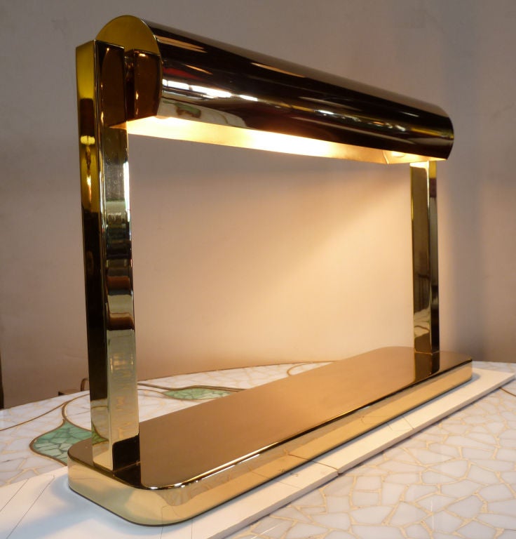 Brass desk lamp by Paul Laszlo.
The 2 arms that hold the shade have a swivel to allow it to tilt up or down.