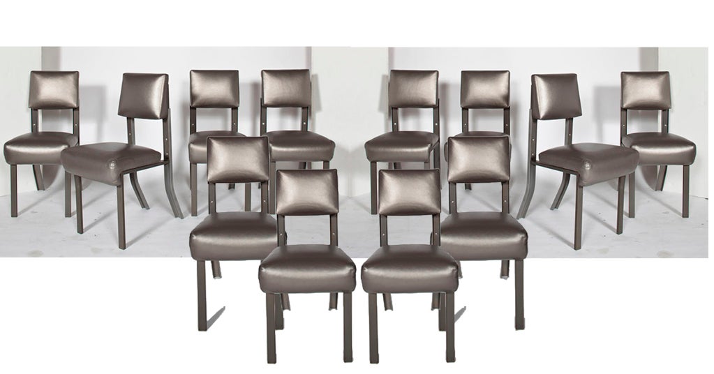 Made of bent, stainless steel this luxurious yet restrained set of side chairs is upholstered in pewter leather. The set was designed by the Los Angeles based designer, Lenny Steinberg.