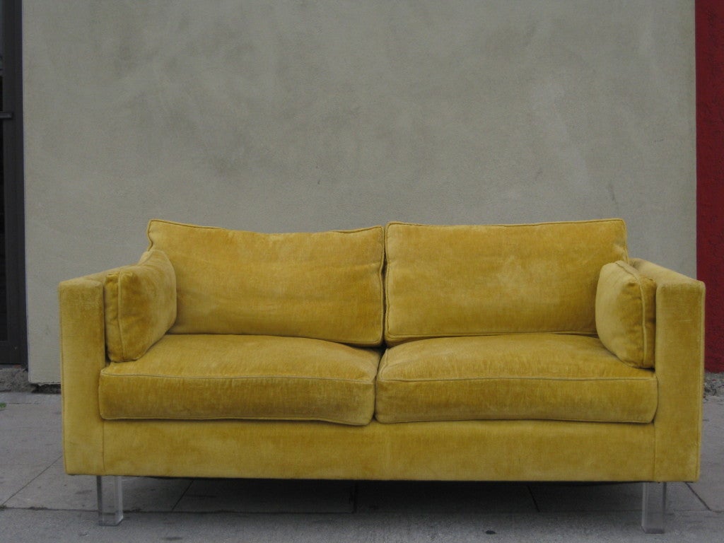 This unique two seat sofa features the original chenille upholstery and side cushions for added comfort. The square legs are in solid lucite giving the sofa the appearance of floating.