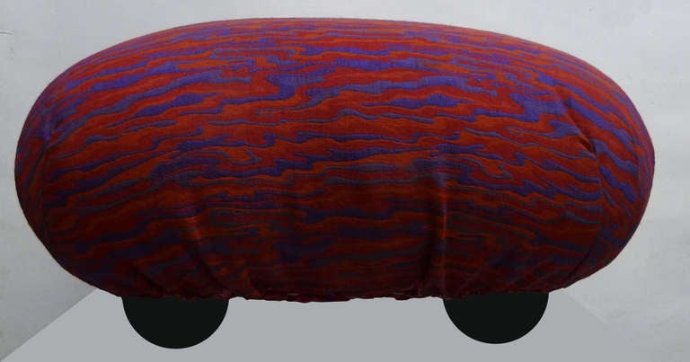 This playful pouf / ottoman by Alessandro Becchi (b. 1946) for Giovannetti features the original flame-like purple, fuchsia and orange upholstery and rests on five dome shaped feet. It is marked beneath 