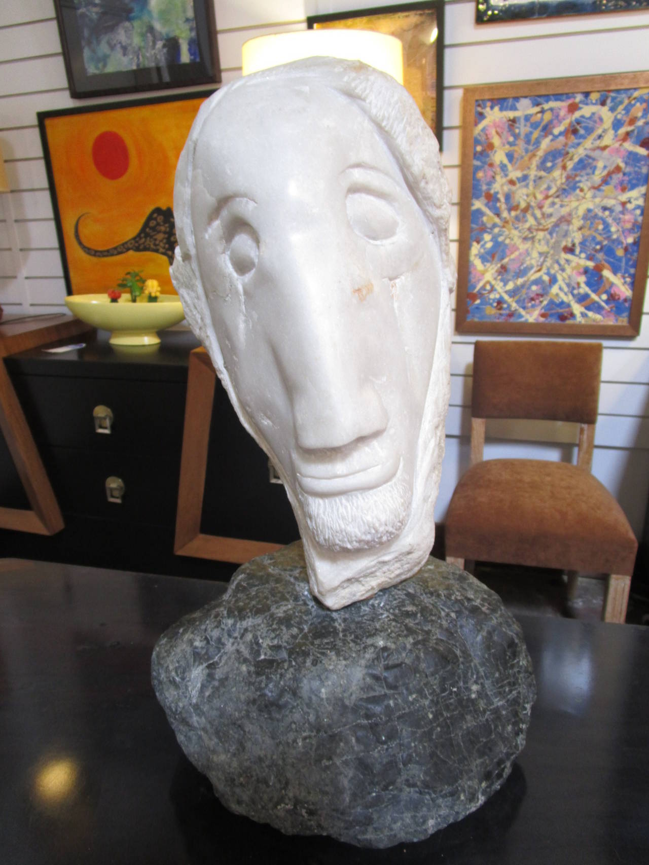 This sculpture is strong by the way it is carved, sharp cuts, the material which is two beautiful pieces of marble, one white and one black and the expression of this man's face.
It is signed Flynn Cody and dated 1999.