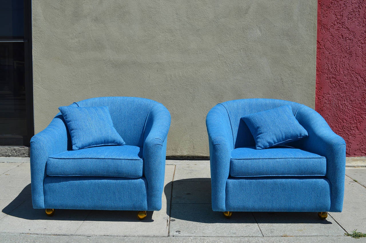 This pair of very comfortable chairs are covered in blue tweed.
The front legs are on brass casters for easier moving.