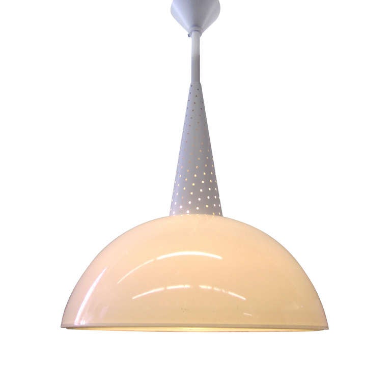 A pendant light by celebrated French designer Mathieu Mategot in enameled metal and opaline featuring Mategot's trademark perforations.
*Please see our listing for a matching pendant in a longer length.