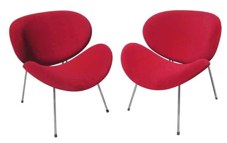 A pair of Pierre Paulin-style orange slice chairs that have been recently reupholstered in a velvety red material. The chairs, which rest on four chrome legs, are extremely comfortable due to the curved seat and back.
These chairs have probably