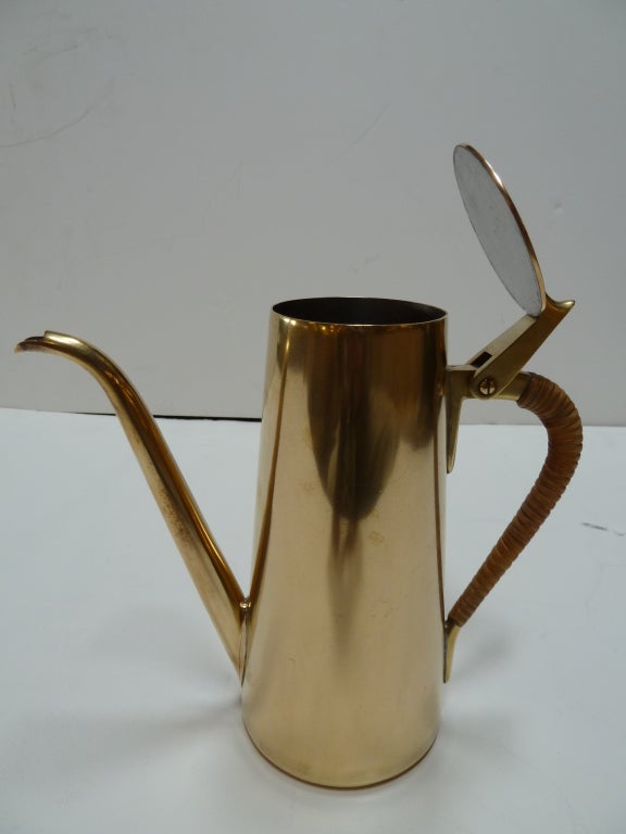 This brass coffee pot was made by Carl Auböck. Wicker was used to cover the handle.